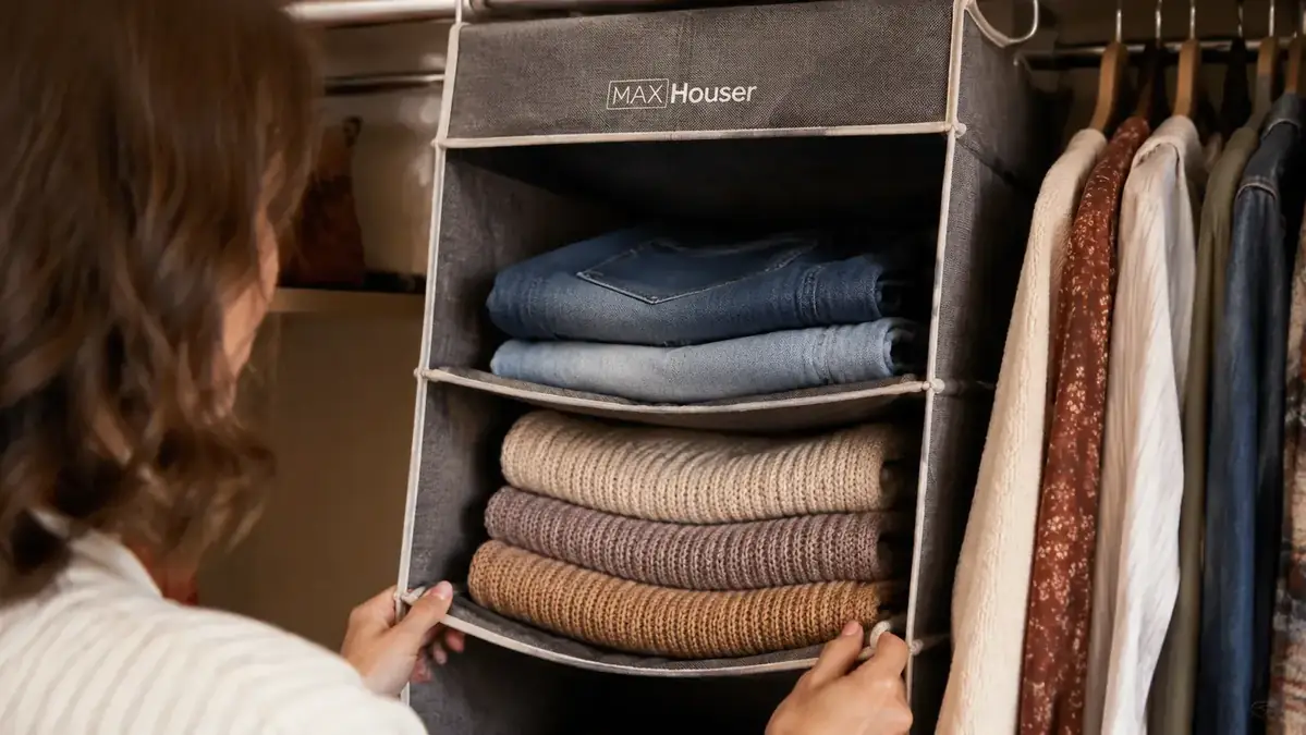 Close-up of the lower two tiers of a MAX Houser hanging shelf sagging forward, with the wire frame corner visibly bowing outward